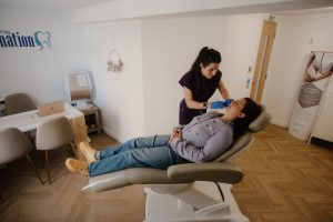 Panoramic clinic view of Dr Morag injecting a patient